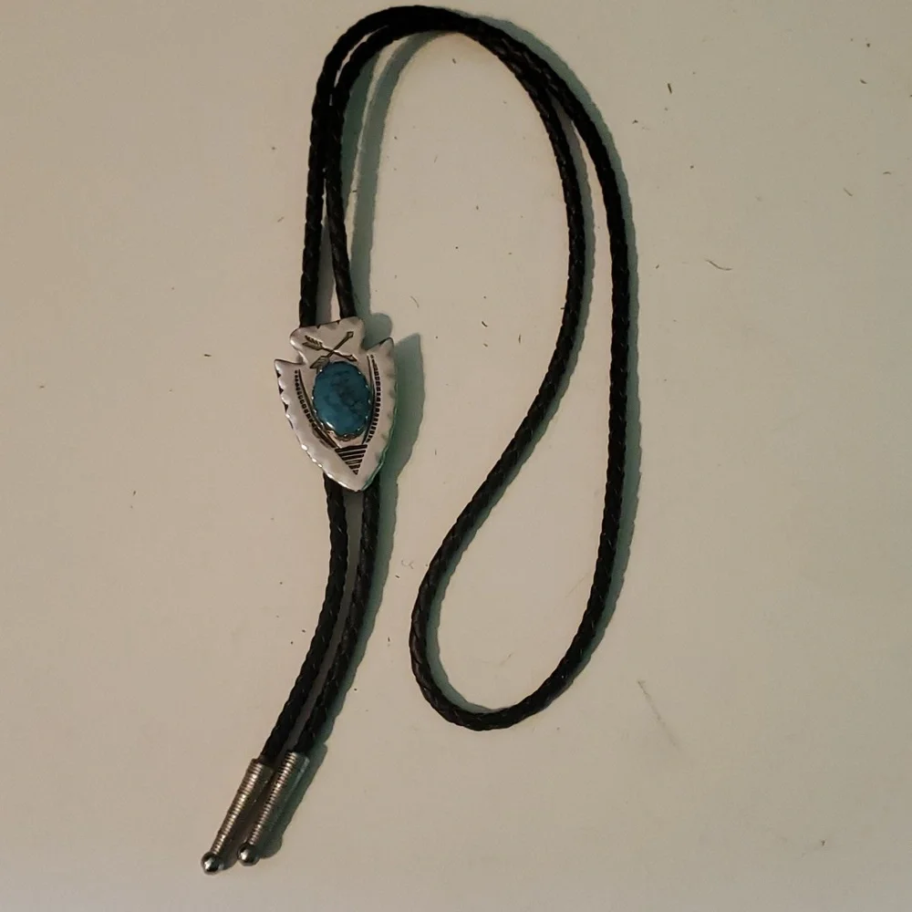 Western Bolo silver tone arrowhead with Turquoise syone on a black bread…